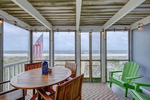 Screened porch / dining area overlooks the beach.