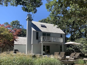 Upper and lower decks look over meadows with a glimpse to Nantucket Sound