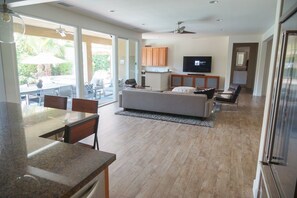 Great Room view from Kitchen, with Sunken Wetbar and 75" 4K Television.