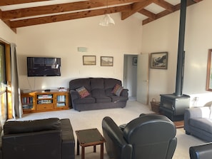 Lounge has comfortable seating TV books,  magazines and games and a log burner.