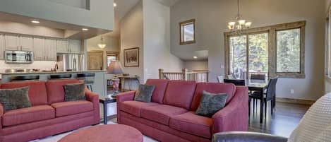 Open floor plan living room, dining area, and kitchen.