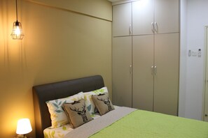 comfortable room with aircond, fan, dressing table and wardrobe