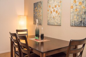 Dining area seats  6 (4 chairs & a bench) & is lit by dimmable overhead lighting