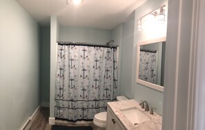 New bathroom with full shower/tub combination.