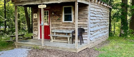 Cabin #9 is nestled in the woods. Picnic table and fire rind provided.