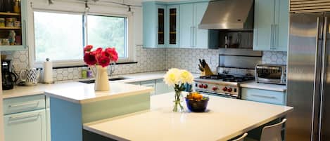 A true chef's kitchen!  Brand new solid quartz countertops, and painted cabinets