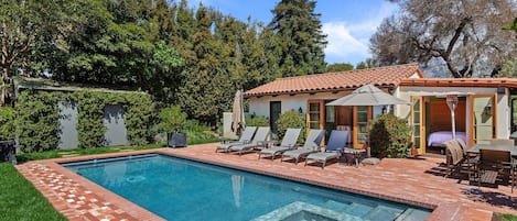 Heated pool and Spa. Large deck with chaise lounges. The house in the background is the pool house and guest house.