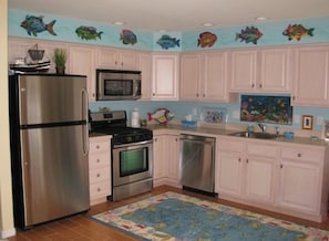 Full kitchen with upgraded stainless steel appliances and beautiful tile floor