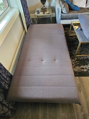 Convertible bed folds flat, very easy to use.