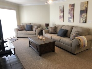 Living room with smart tv, and queen size pullout bed