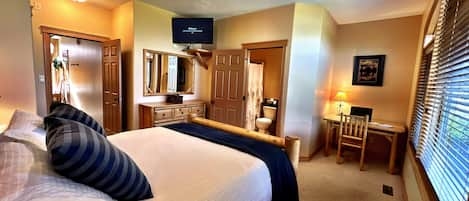 Master Bedroom with custom log Queen Bed, TV, Cable and s Desk (just in case you need to do some work?).