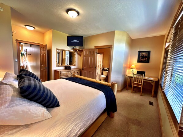 Master Bedroom with custom log Queen Bed, TV, Cable and s Desk (just in case you need to do some work?).