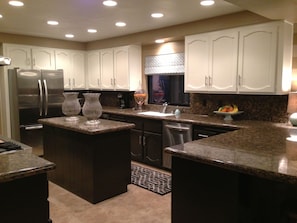 Cooks kitchen has all new stainless steel appliances and wine refrigerator.