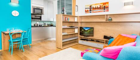Colorful mini living room and fully equipped kitchen