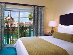 Spacious bedroom with king bed and view of balcony.