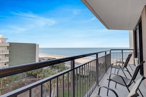 Cozy chairs await you near the glass door of our suite, inviting you to relax and soak in the breathtaking views from your private balcony.