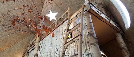 Birch ladder to the loft, star skylights, moon window, bedroom behind the wall