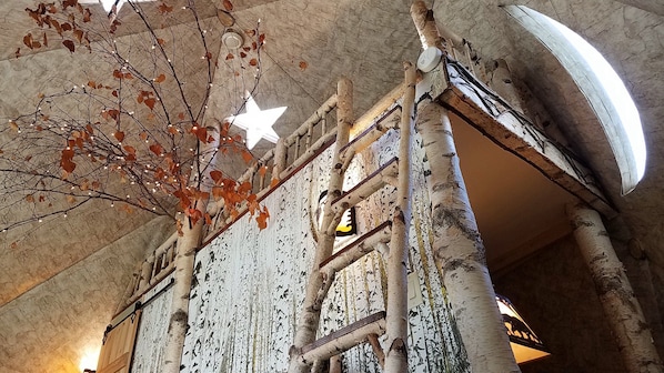 Birch ladder to the loft, star skylights, moon window, bedroom behind the wall