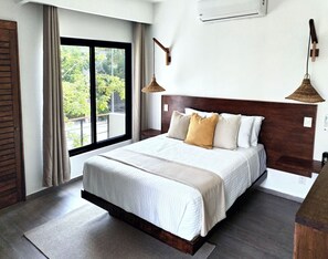 Bedroom 5 with a beautiful balcony full of light and vegetation.