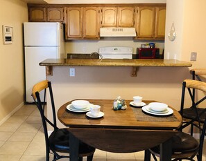 Kitchen and dining area. Granite countertops throughout.