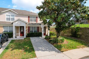 Charming front exterior with a lush green yard and inviting curb appeal.