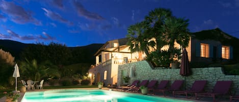 Night View of Pool, House and Mountains