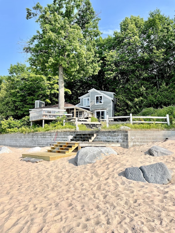 View of cottage and deck from beach shoreline