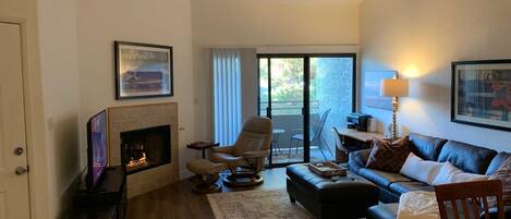 Vaulted ceilings, natural gas fireplace and balcony off the living room.