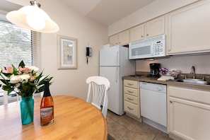 The unit is equipped with a kitchen and features a dining table for your convenience.