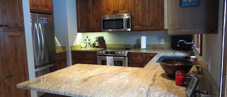 Custom alder wood cabinetry and granite counter tops.  Water purifier system.