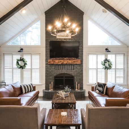 Picture perfect living room in the MAIN house has 2 couches and 2 arm chairs.