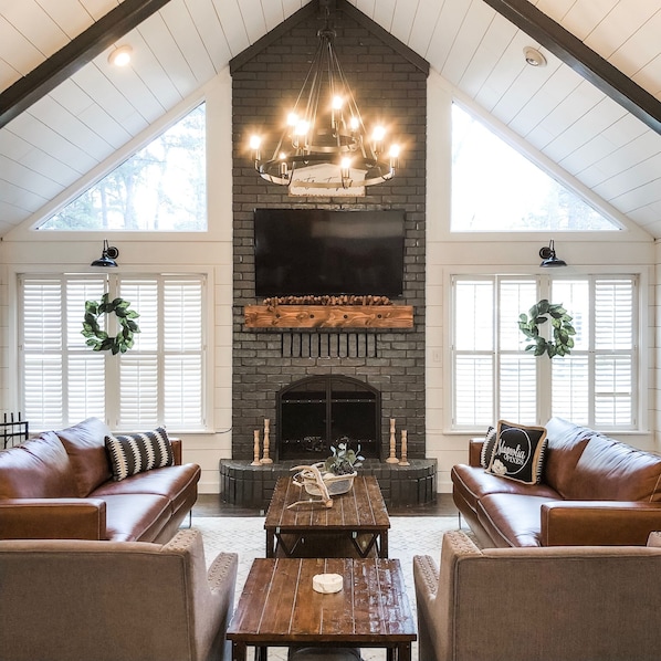 Picture perfect living room in the MAIN house has 2 couches and 2 arm chairs.