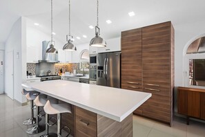 Elevate your cooking experience in our sophisticated, fully furnished kitchen.