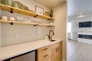 Bedroom 1 on the ground floor boasts a wet bar, mini-fridge, and gorgeous gas fireplace!