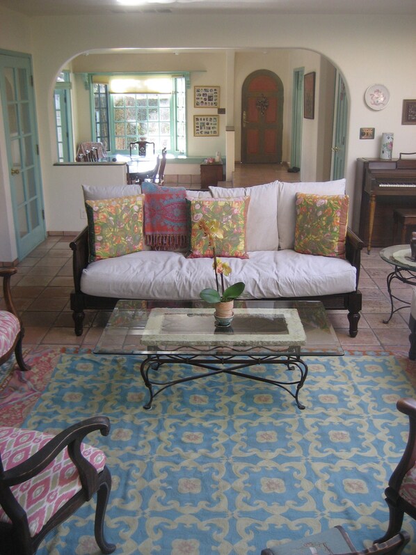 Living Room with fireplace, surrounded by French doors leading to garden