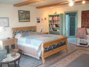 Master bedroom with a view to the ocean and a handcrafted fireplace