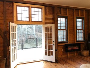 Gorgeous French doors onto spacious glass railing deck