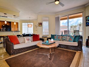 Comfy seating in the living room with balcony access.