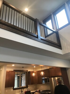 Living room looking up to natural light in loft. 