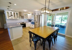 Open plan kitchen includes microwave, dishwasher, and many small appliances