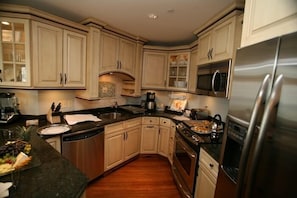 Kitchen: shows appliances, serving and bar area. Dining table not in photo.