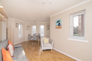 Lounge area with sofa bed looking towards oriel window 