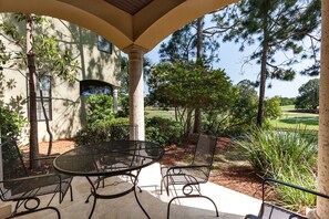 Back covered patio overlooking the golf course lake