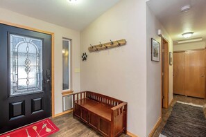 Entry way into the home has plenty of coat hooks and a place to store your shoes. 