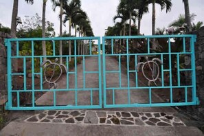 Turtle House gates, requiring security code to enter. Lava Rock Wall surrounds