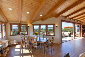 Dining room and upper deck with open bi-fold doors.