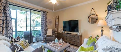 Living room with view of water and 11th hole on Golf Course. 