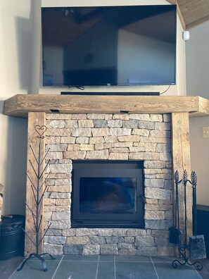 Updated fireplace with wood stove insert (keeps unit  toasty warm) 