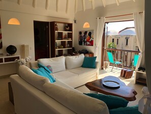 Main living space. Kitchen on the left at the back and master bedroom thru door