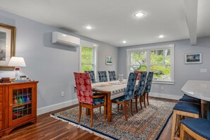 Dining room with seating for 8, plus additional seating at the bar.